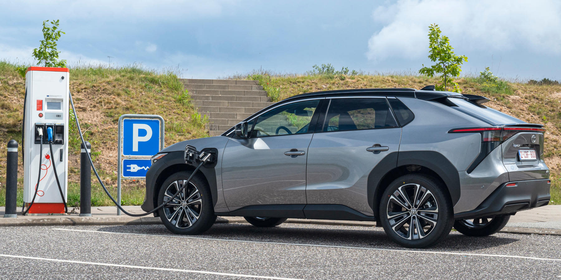 Toyota bZ4X auf Parkplatz beim Aufladen an einer Ladesäule